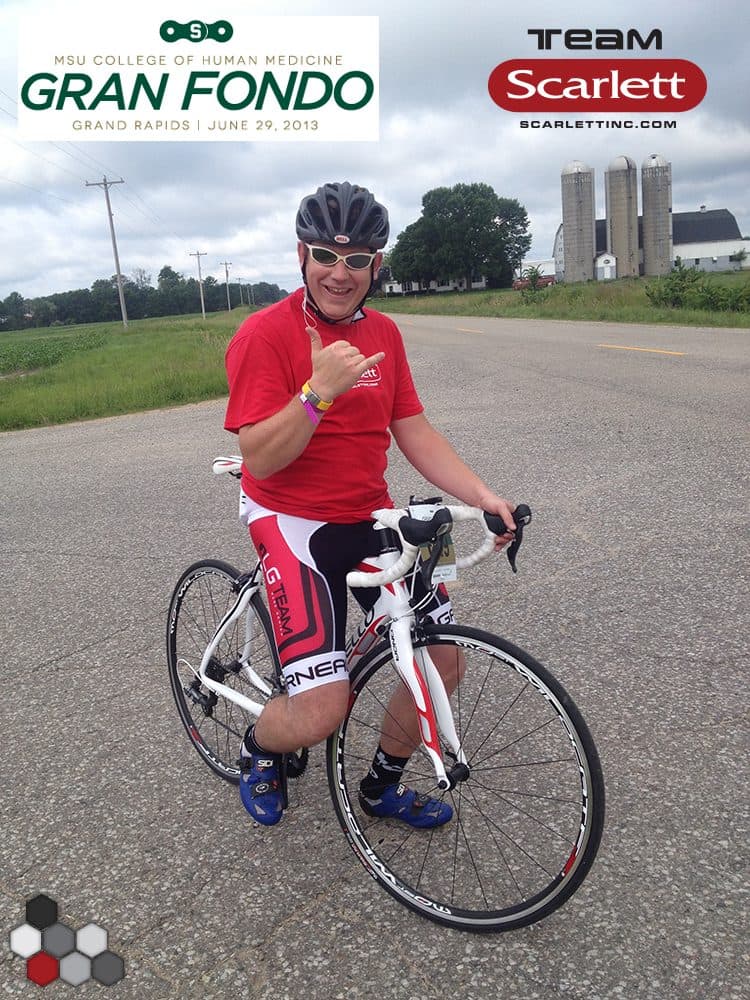James in Team Scarlett cycling kit with his road bike at the MSU Gran Fondo