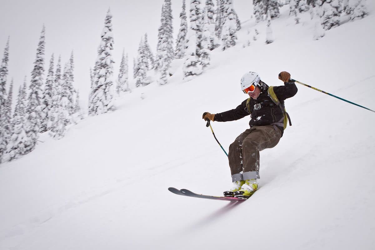 James skiing deep powder between snow-covered trees