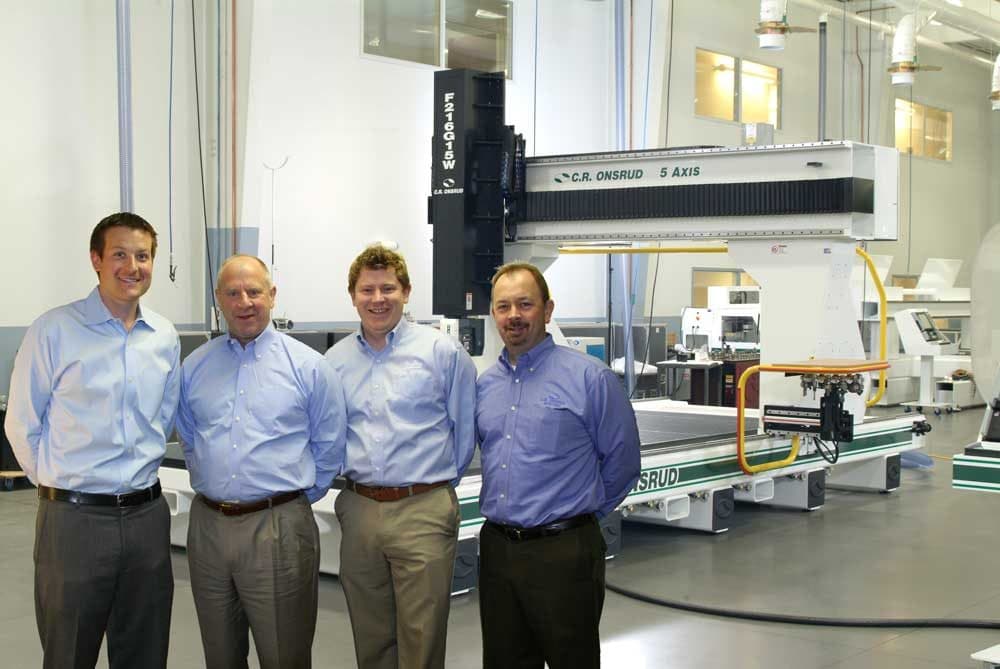 James and colleagues beside a C.R. Onsrud CNC machine in the Scarlett showroom