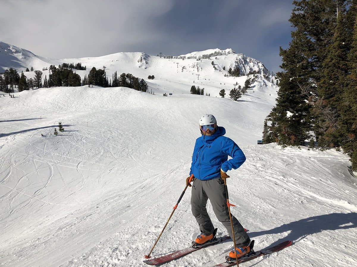 James pausing mid-run on a wide mountain ski slope