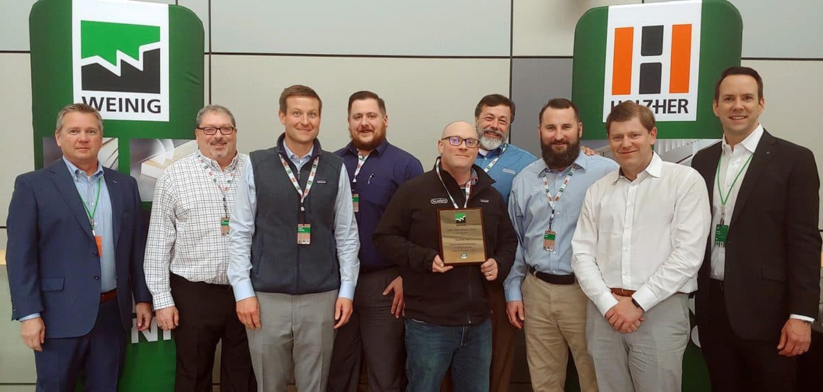 James and colleagues accepting an award at a woodworking machinery trade show
