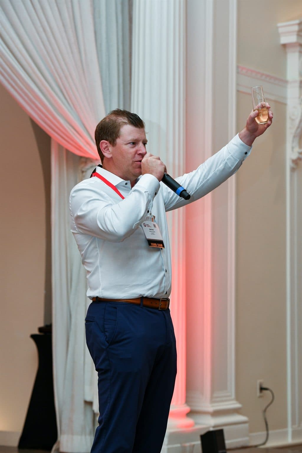 James raising a glass while giving a toast at an industry gathering