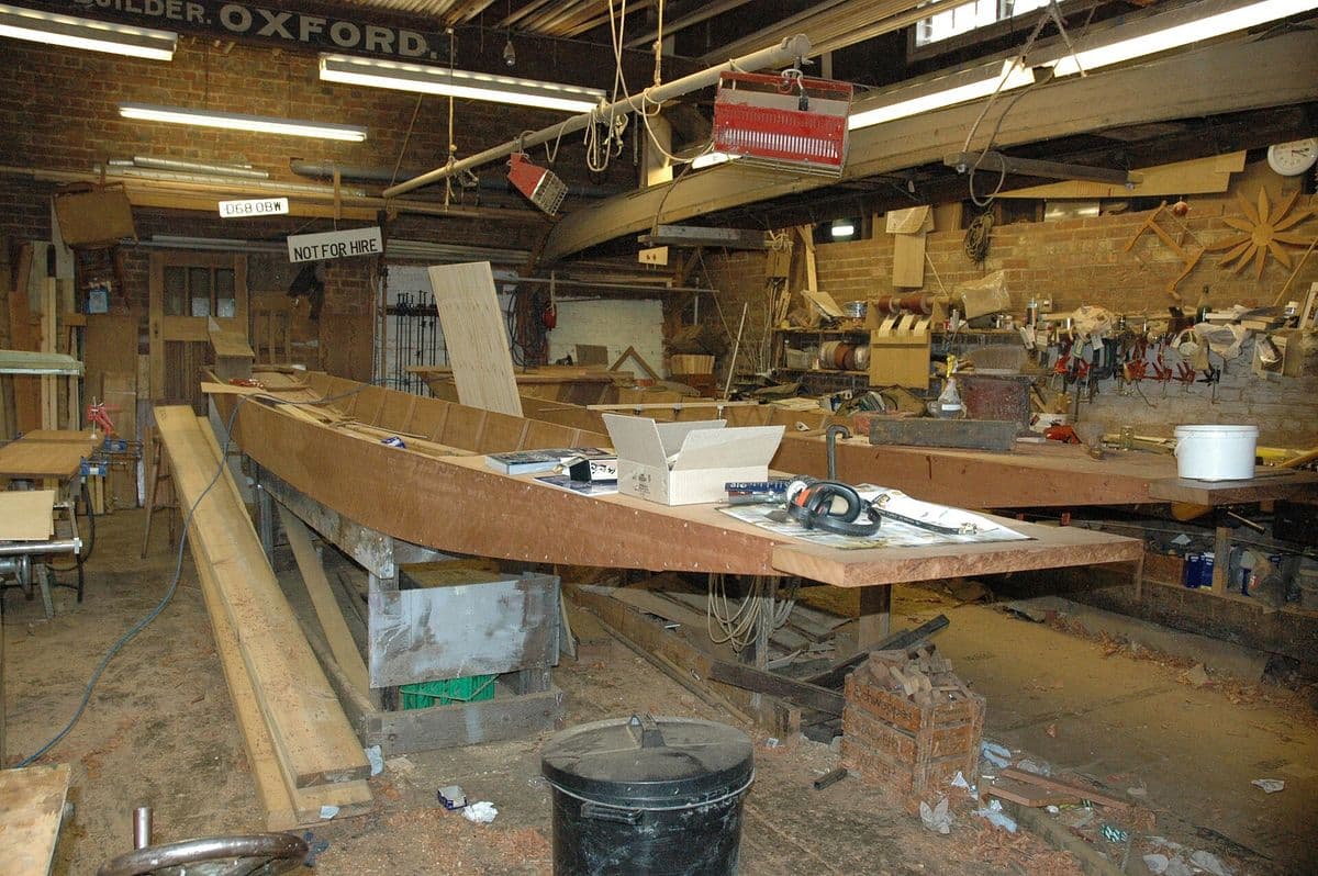 Wooden boat hull being built in a boatbuilding workshop