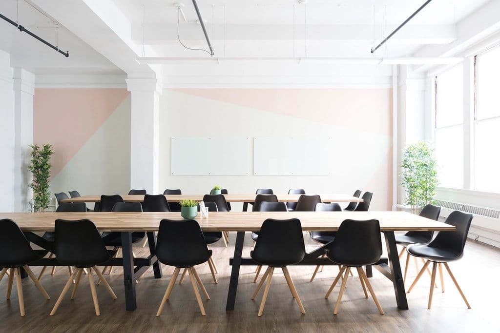 Bright modern office with long wooden conference tables