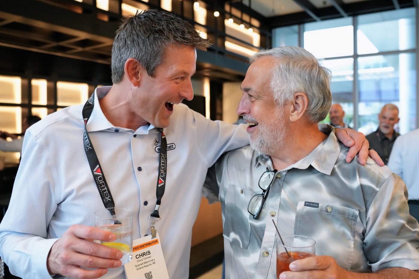 Two guests sharing a laugh at the cocktail hour