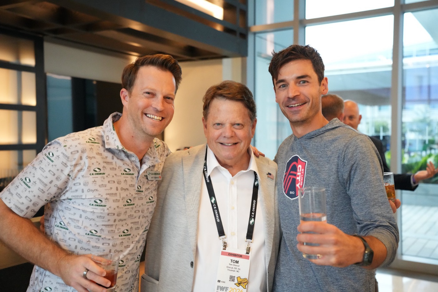 Three guests with drinks at the cocktail hour