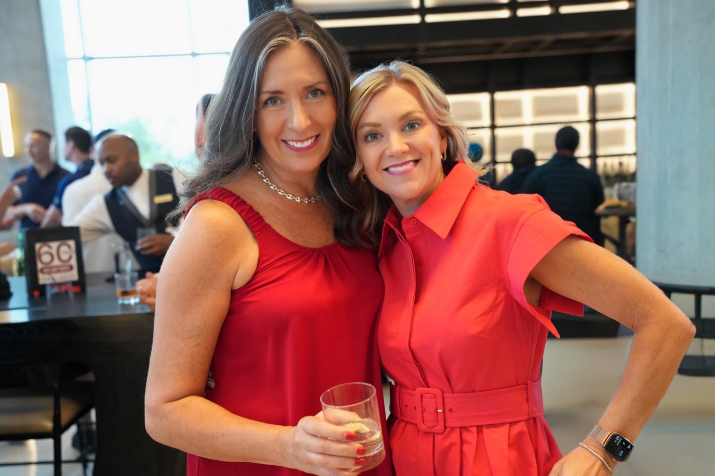 Two guests in red at the Scarlett 60th anniversary cocktail hour at the Signia by Hilton Atlanta