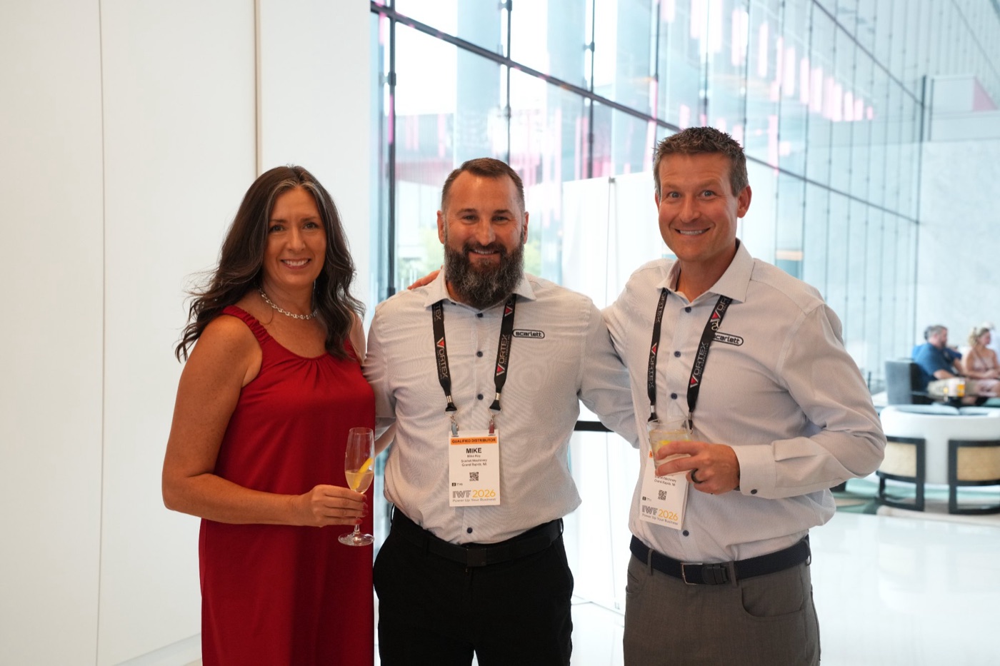 Three guests wearing IWF badges at the Scarlett cocktail hour