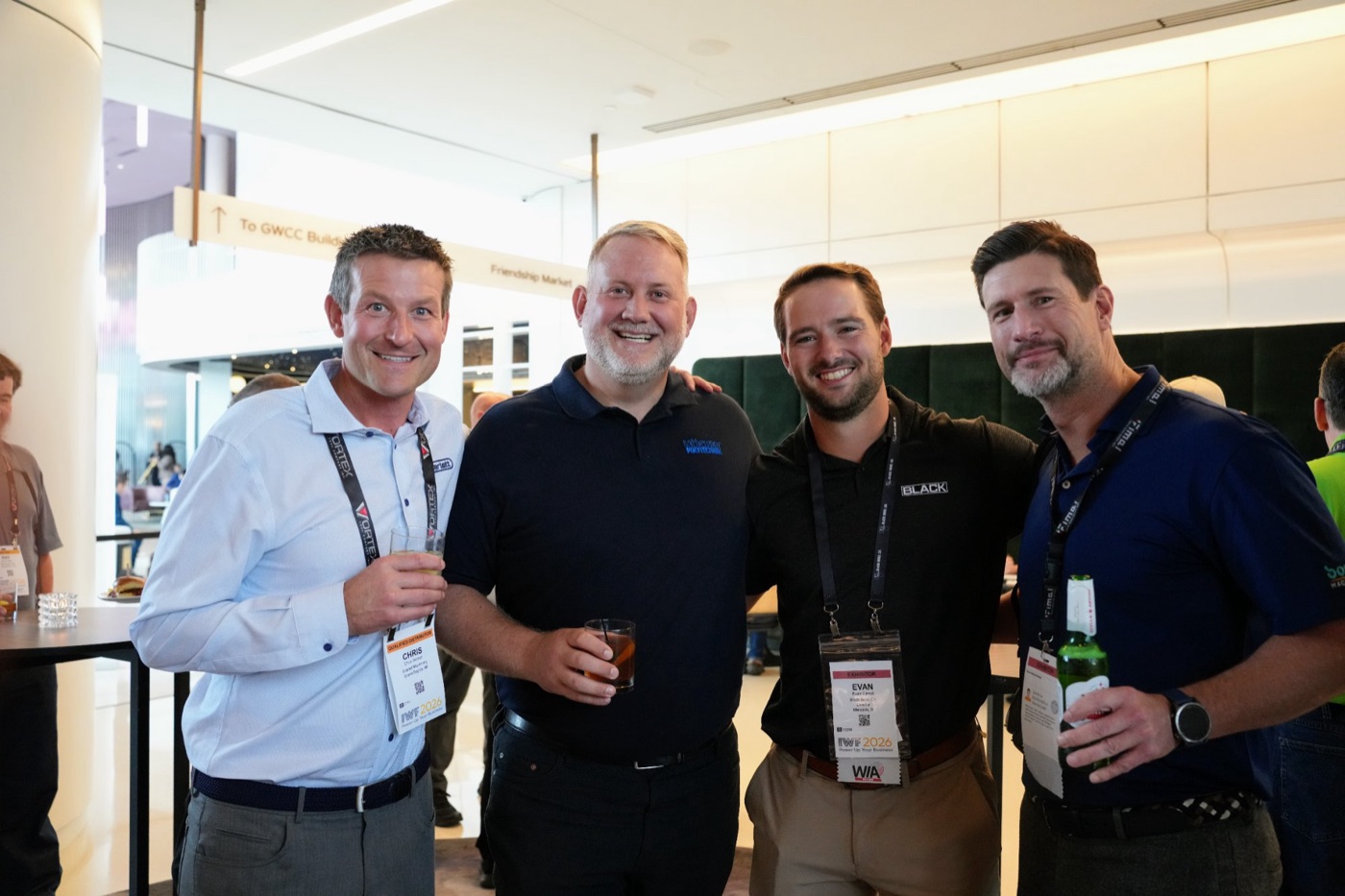 Four guests with drinks at the Scarlett cocktail hour